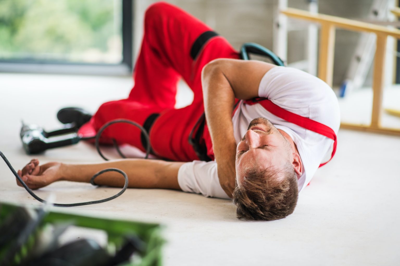 An accident of a man worker at the construction site.