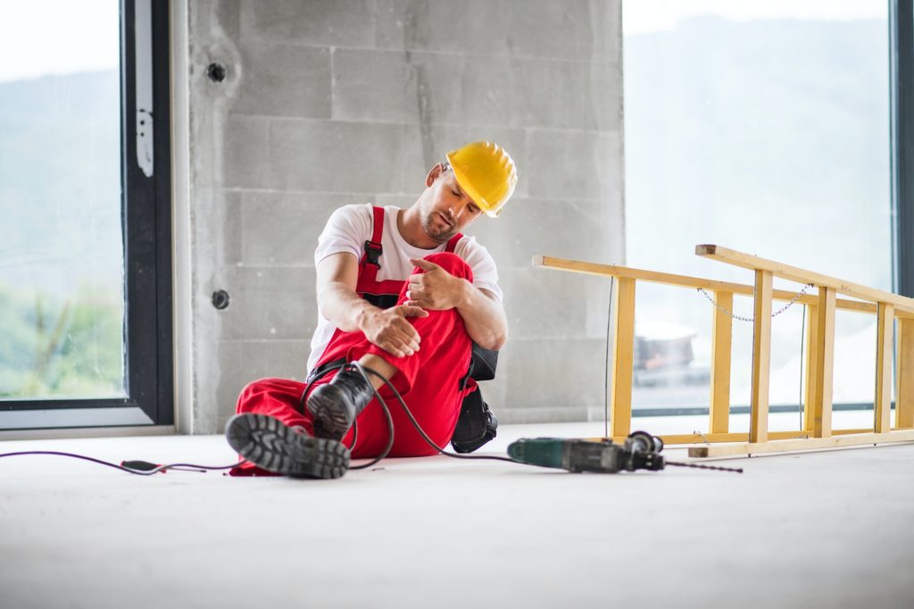 An accident of a man worker at the construction site.