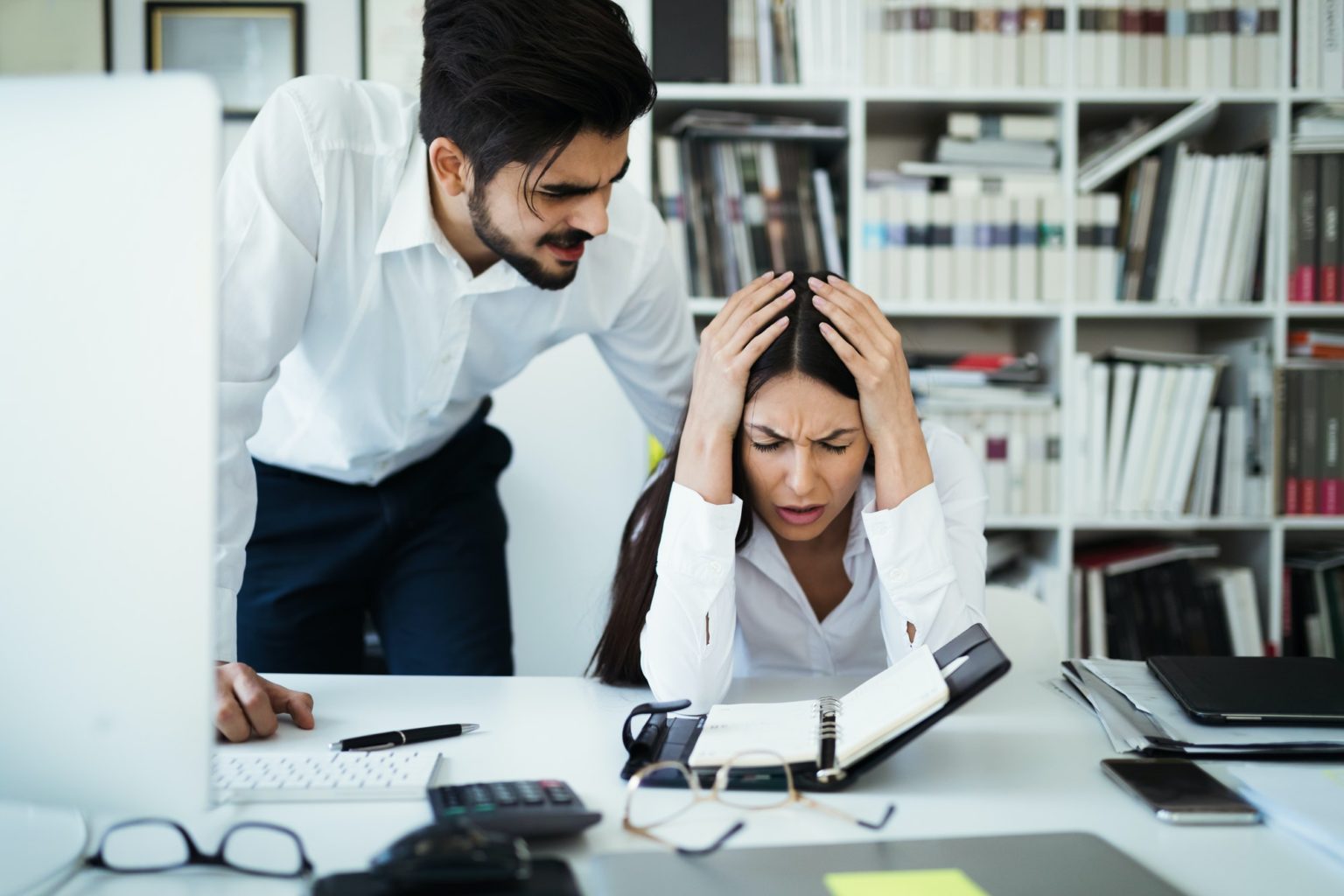 Angry irritated boss reprimanding employee afraid to be fired, bad work