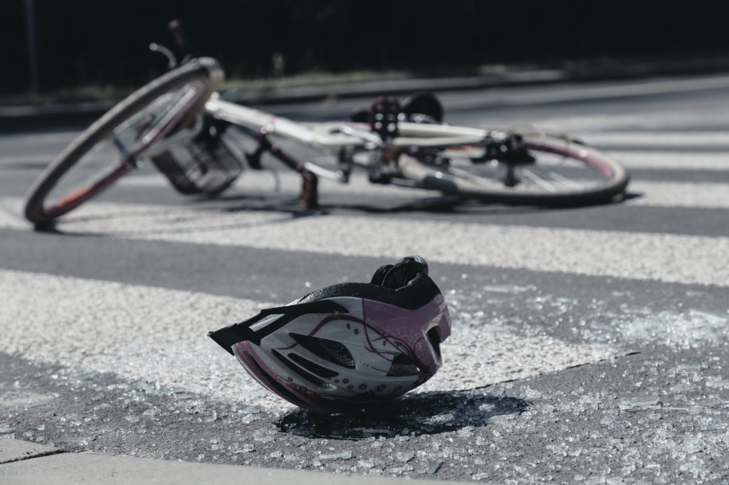Broken child's helmet and bike on pedestrian crossing after terr