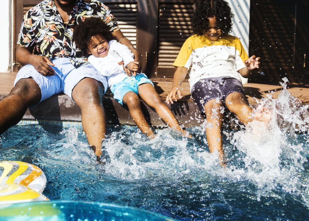 Family playing in a pool